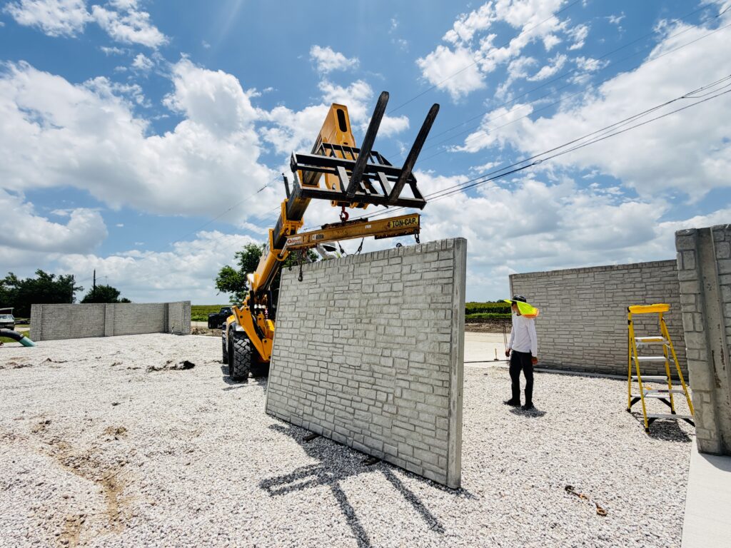 Crane setting a precast concrete panel into place during installation by Dayd Masonry in the Dallas-Fort Worth, TX area