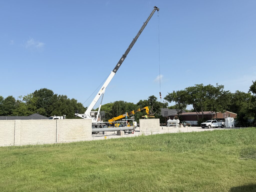 Precast concrete panel wall installation in progress with crane on site by Dayd Masonry in the Dallas-Fort Worth, TX area