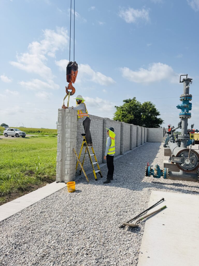 Precast concrete panel being lowered into position by crane during a Dayd Masonry install in the Dallas-Fort Worth, TX area